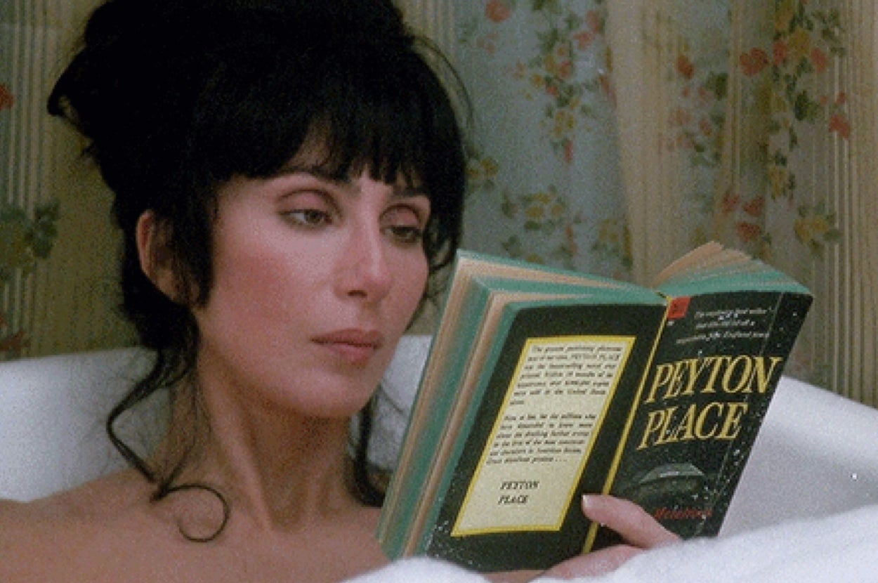 Cher in the movie "Mermaids" sits in a bathtub, reading the book "Peyton Place"