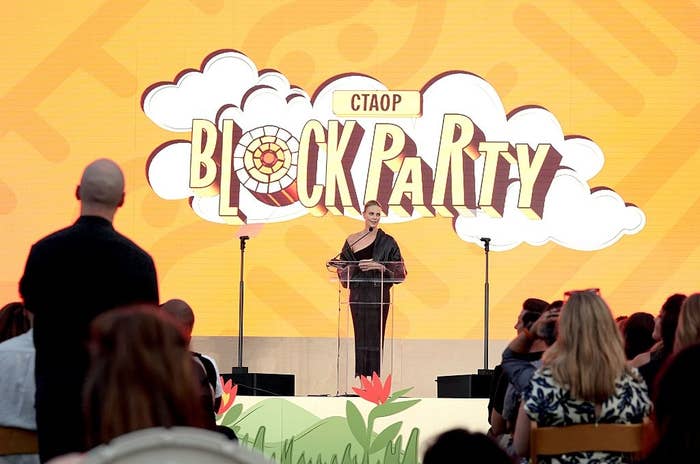 Person speaking on stage at the CTAOP Block Party event. Audience members are seated and listening