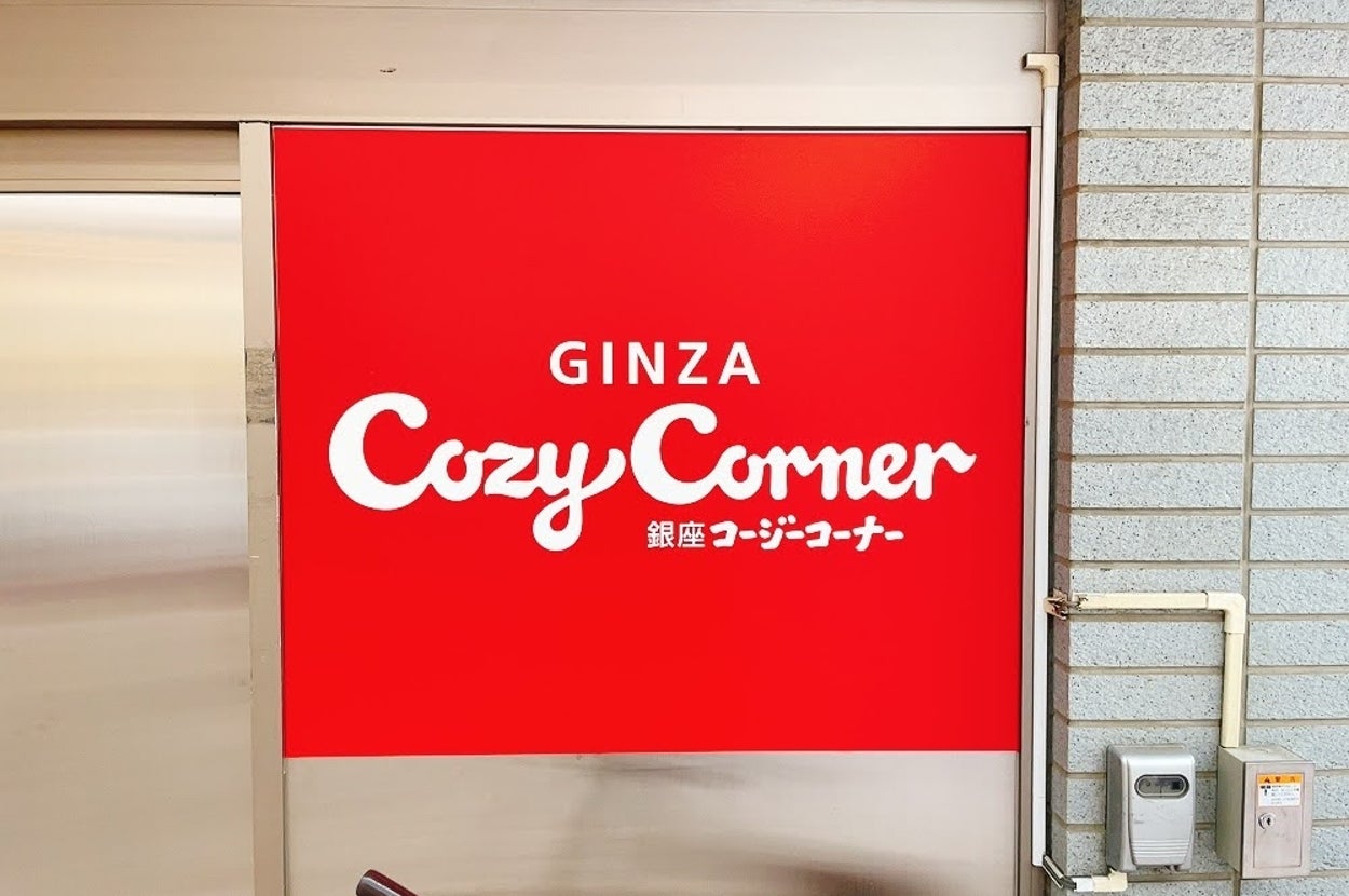 銀座コージーコーナーの看板。店舗入口付近の様子が映されている。