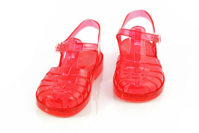 Pair of transparent integrative  jelly sandals with buckled ankle straps