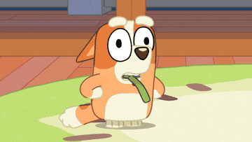 Animated dog character from a TV show wiggles its ears happily while holding a toy