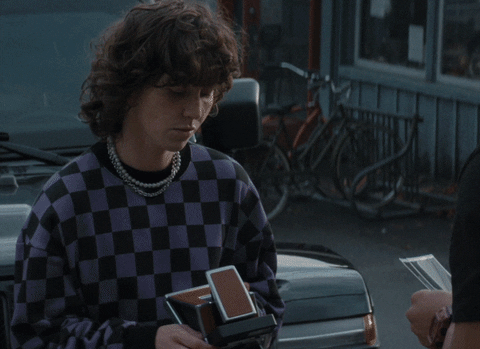 Person holding instant camera film in a moody street scene; Goosebumps, Hulu, and Disney+ logos visible