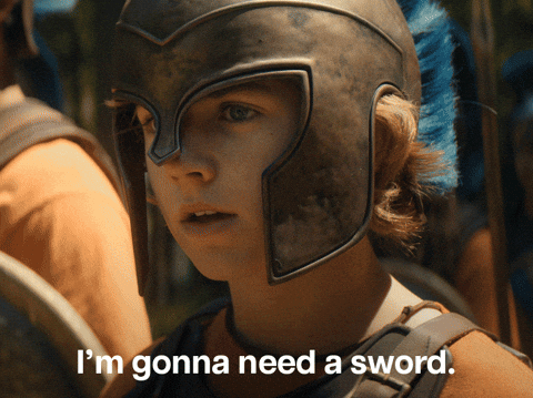 Young warrior in a helmet says, \"I\&\#x27;m gonna need a sword,\" with a Disney+ logo. They appear ready for battle action