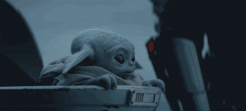 Baby Yoda, also known as Grogu, sits in a floating pod, gazing around cautiously. Scene from \"The Mandalorian\" on Disney+