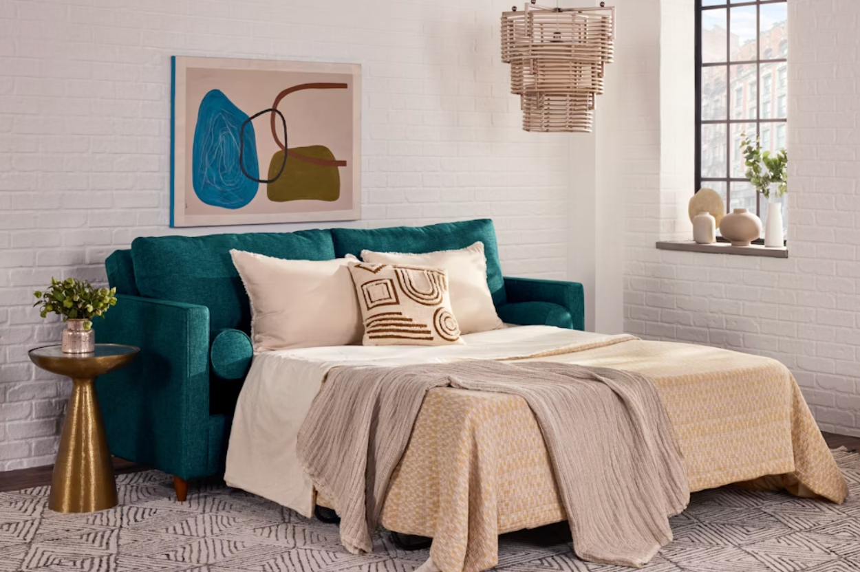A stylish surviving  country   features a teal sofa bed, abstract artwork, a woven pendant light, and modern   decor, illustrating a cozy, multifunctional space