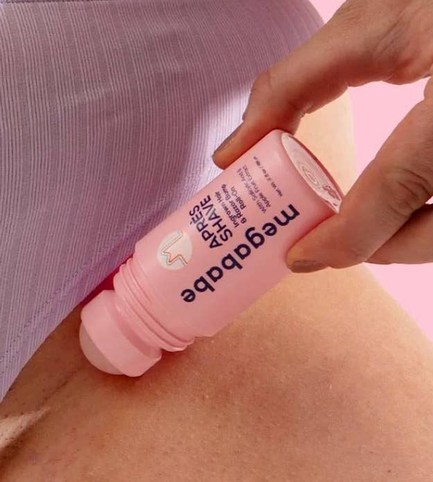 Hand utilizing a Meagababe Après Shave roller connected  bikini line