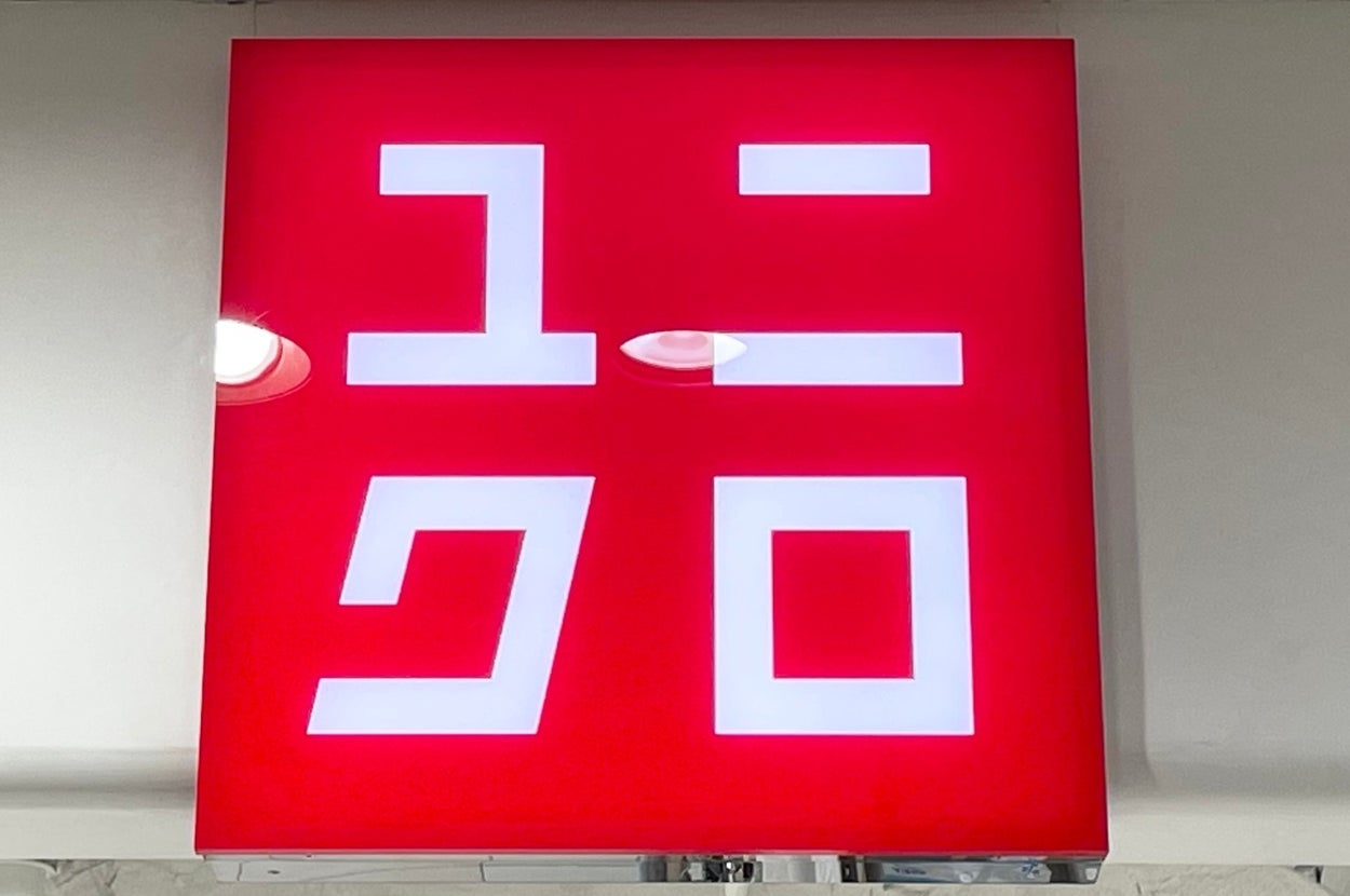 Red sign with white text displaying the Uniqlo logo in a store setting