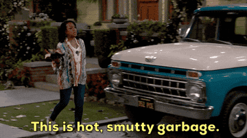 Woman in a patterned top walks past an old truck, holding papers. The caption reads, &quot;This is hot, smutty garbage.&quot;