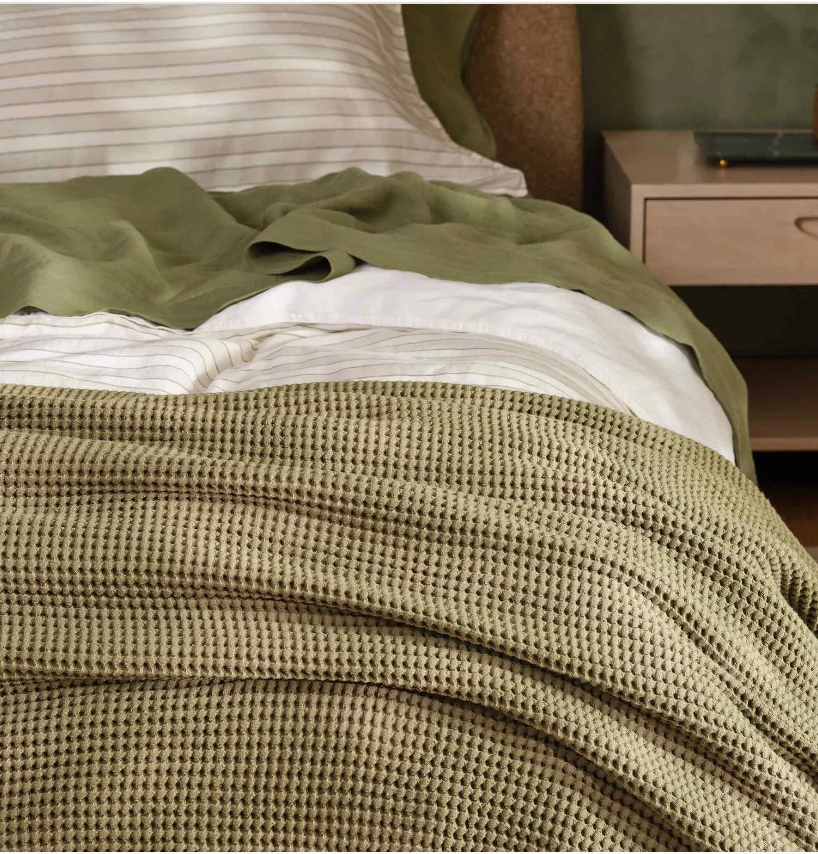 Cozy chamber  with neatly arranged bedding, featuring a textured broad  and neutral-toned sheets connected  a modern   bed