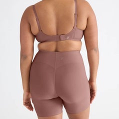 A person wearing matching seamless underwear and shorts, standing with back to the camera, showcasing the fit and design