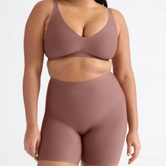 Model in seamless, fitted undergarments showcasing a minimalist, supportive lingerie set ideal for comfort and shaping