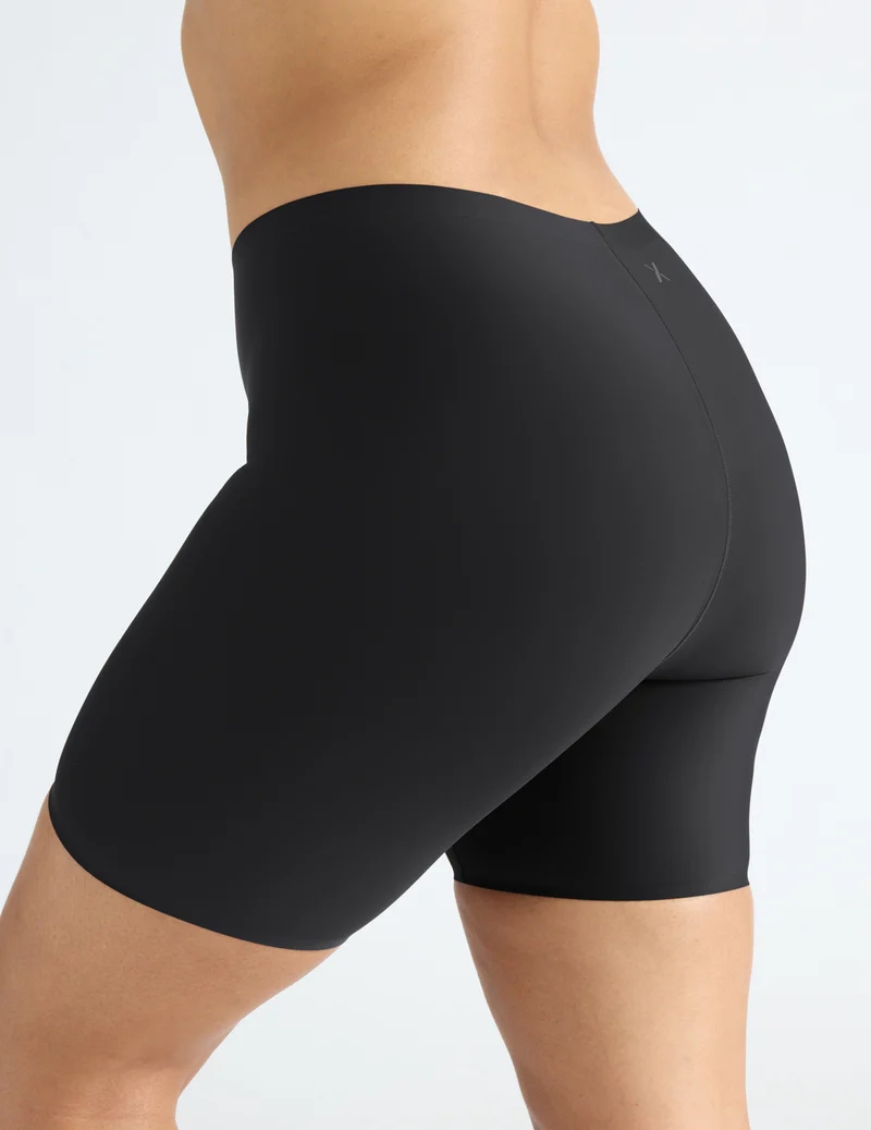 Person wearing seamless black bike shorts, shown from the back, highlighting the shorts&#x27; fit and design