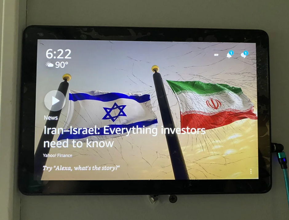Alexa device screen showing Israeli and Iranian flags and the headline: &quot;Iran-Israel: Everything investors need to know&quot; from Yahoo Finance