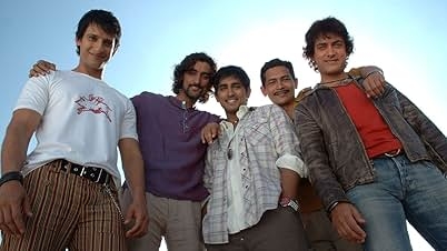 Five people stand in a relaxed pose, smiling. One wears a leather jacket, others wear casual shirts and t-shirts. Sky in the background