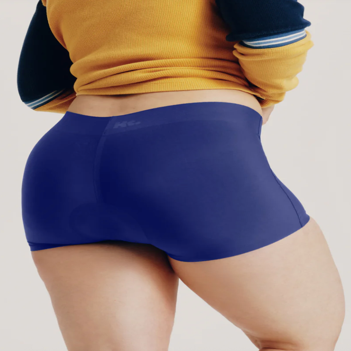 Person wearing seamless blue boxer briefs, showcasing fit and comfort