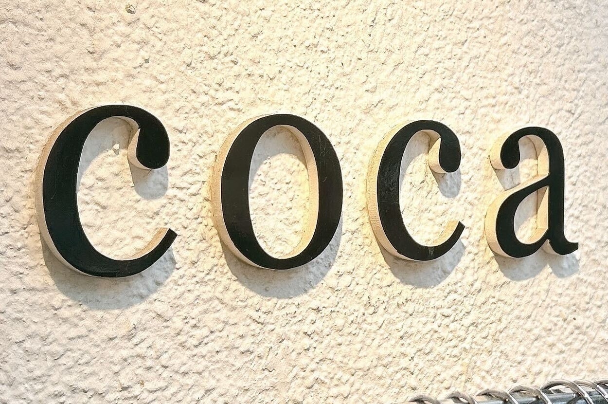 壁に「coca」の店名表示。手前には服が並んでいる。