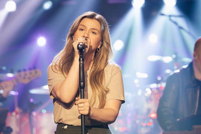 Person singing passionately connected  signifier    with a microphone, set  blurred successful  the background, melodramatic  lighting enhances show  ambiance