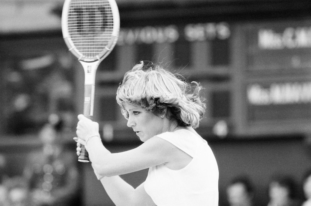 Tennis player preparing to hit a backhand shot during a match