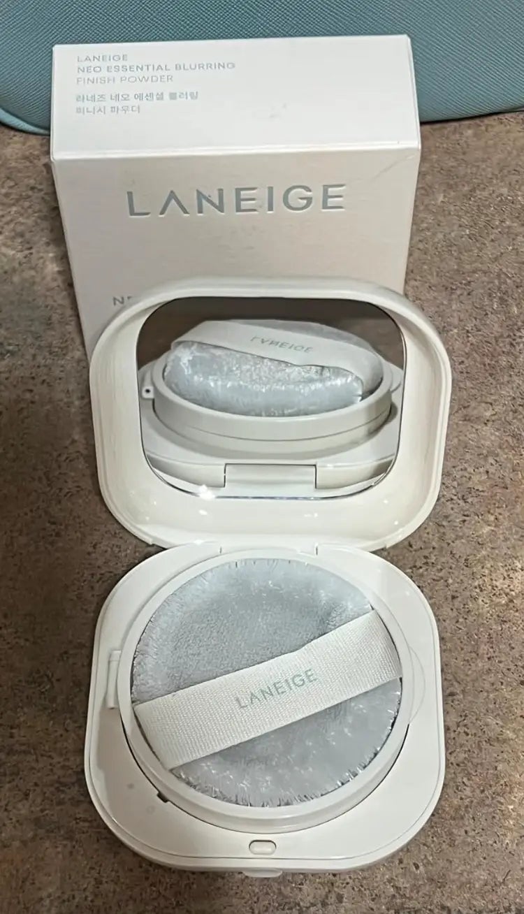 Laneige Neo Essential Blurring Finishing Powder compact with applicator and box, displayed connected  a surface