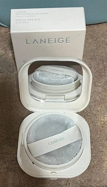 Laneige Neo Essential Blurring Finishing Powder compact with applicator and box, displayed connected a surface