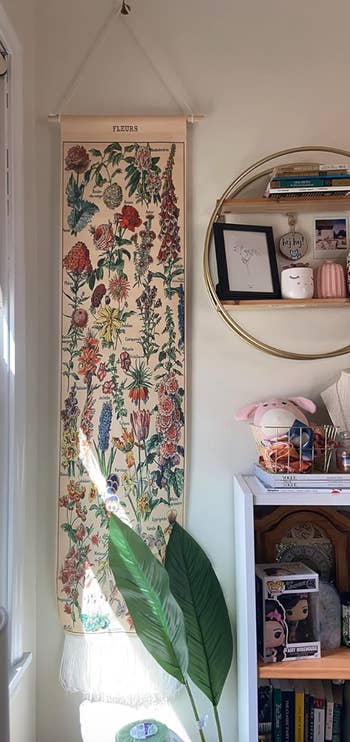 Wall decor successful a country with a floral tapestry labeled