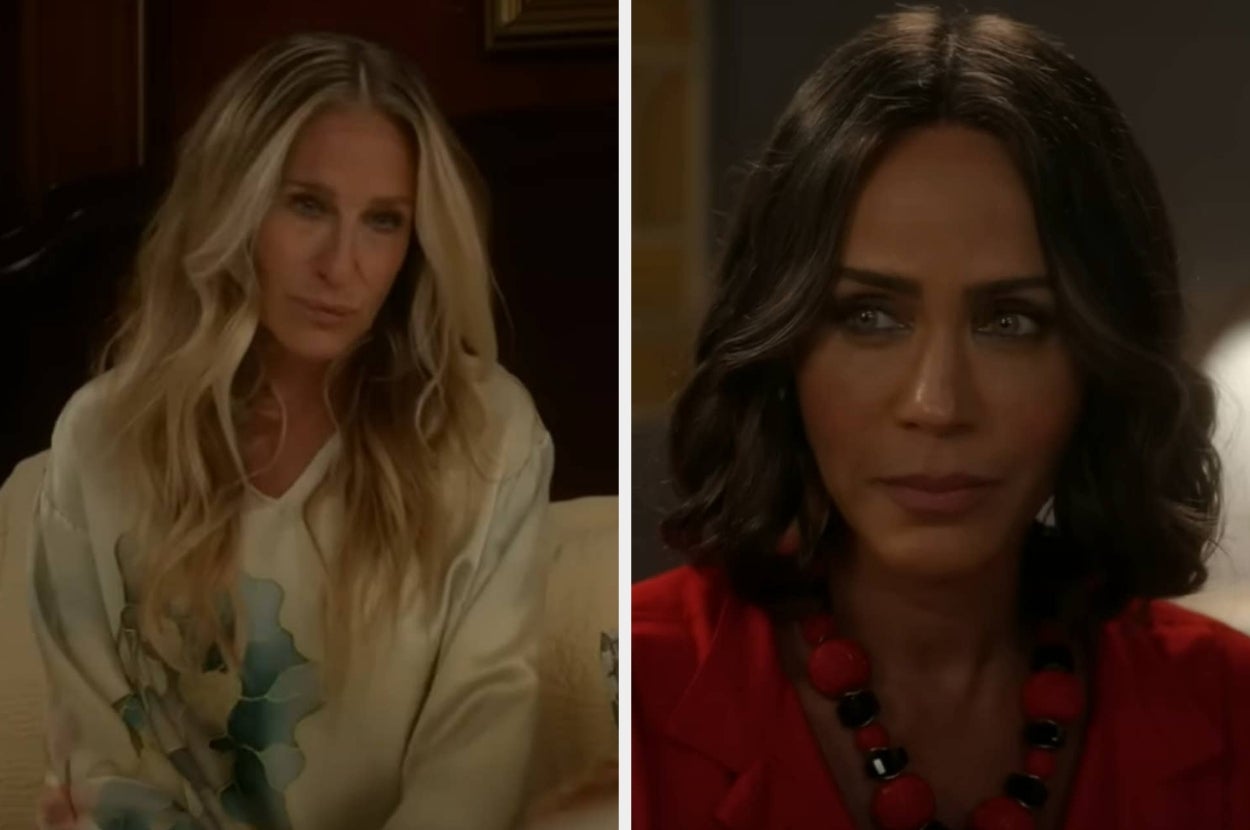 Two women in a TV scene, one with long wavy hair in casual wear, the other with short hair in a red outfit with a black and red necklace