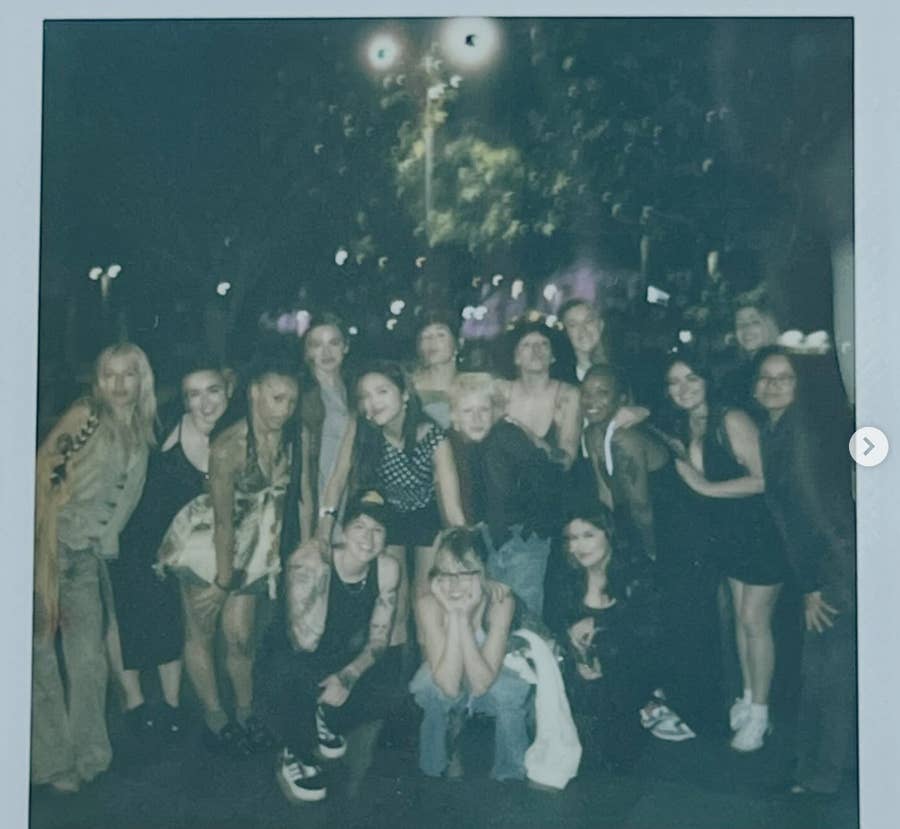 A Polaroid capturing the joyous camaraderie of Olivia Rodrigo's tour crew during an evening gathering.