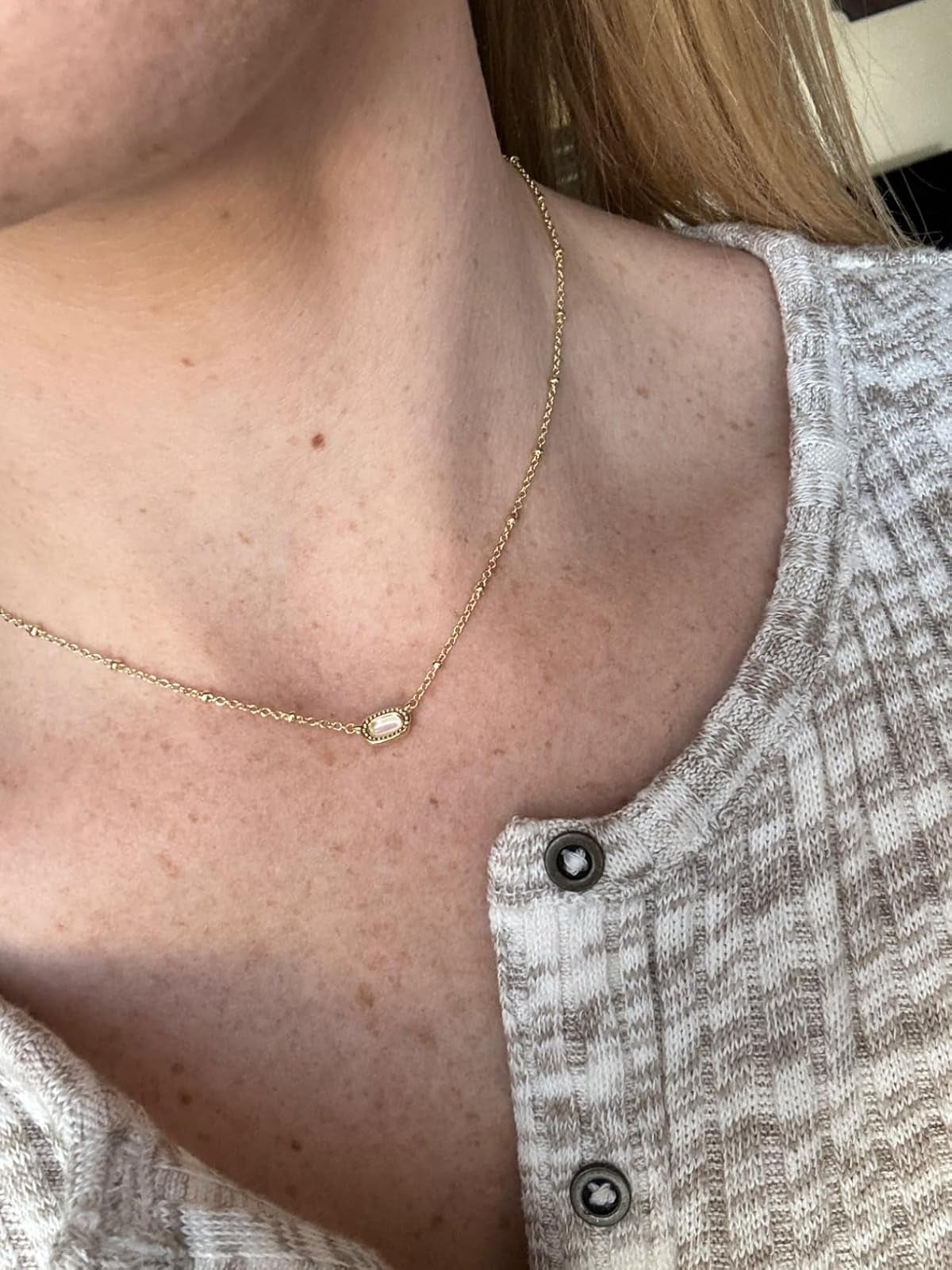 Close-up of a idiosyncratic   wearing a bladed  concatenation  necklace with a tiny  pendant