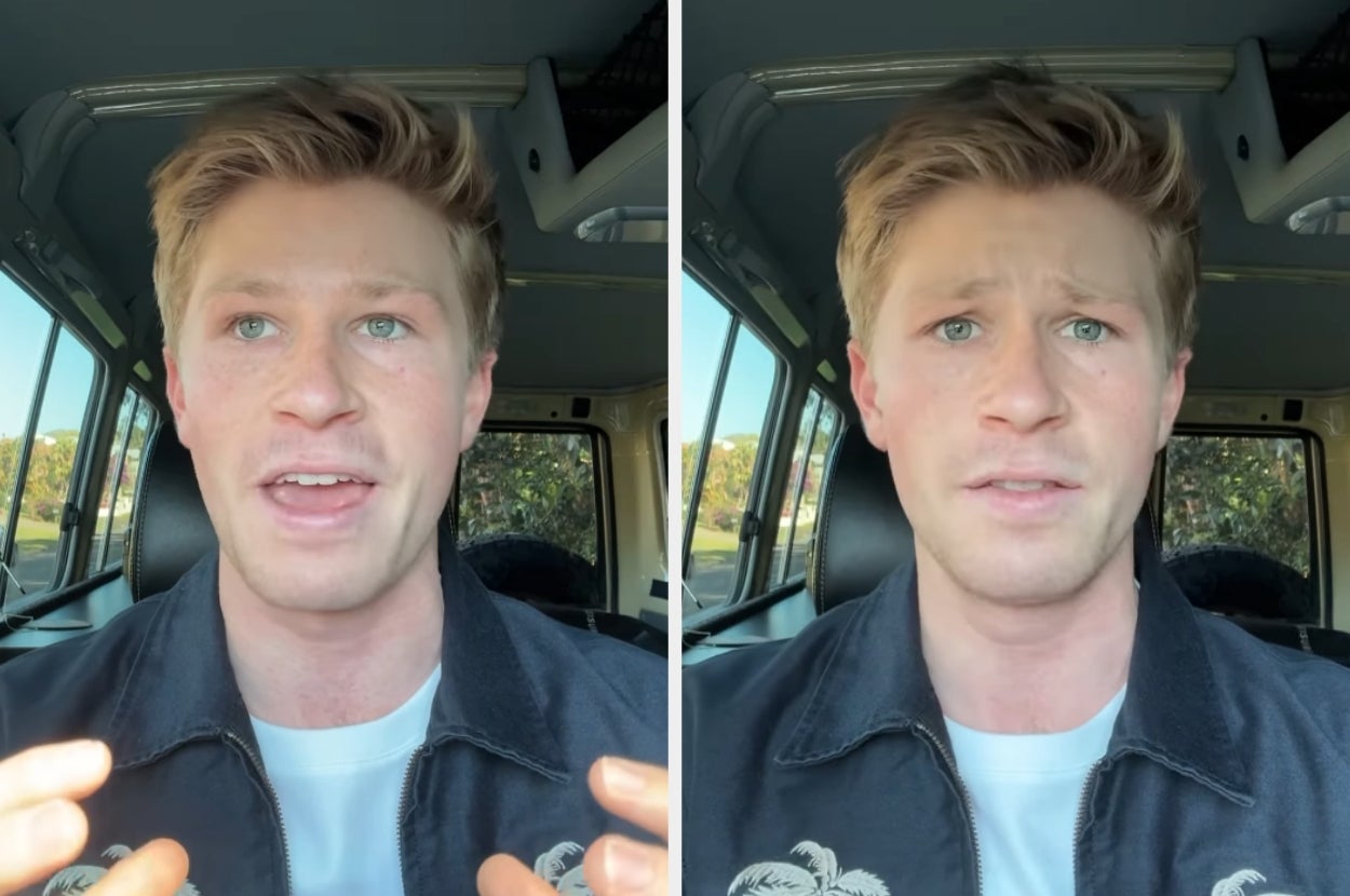 Person speaking in a vehicle, gesturing with hands, wearing a casual jacket