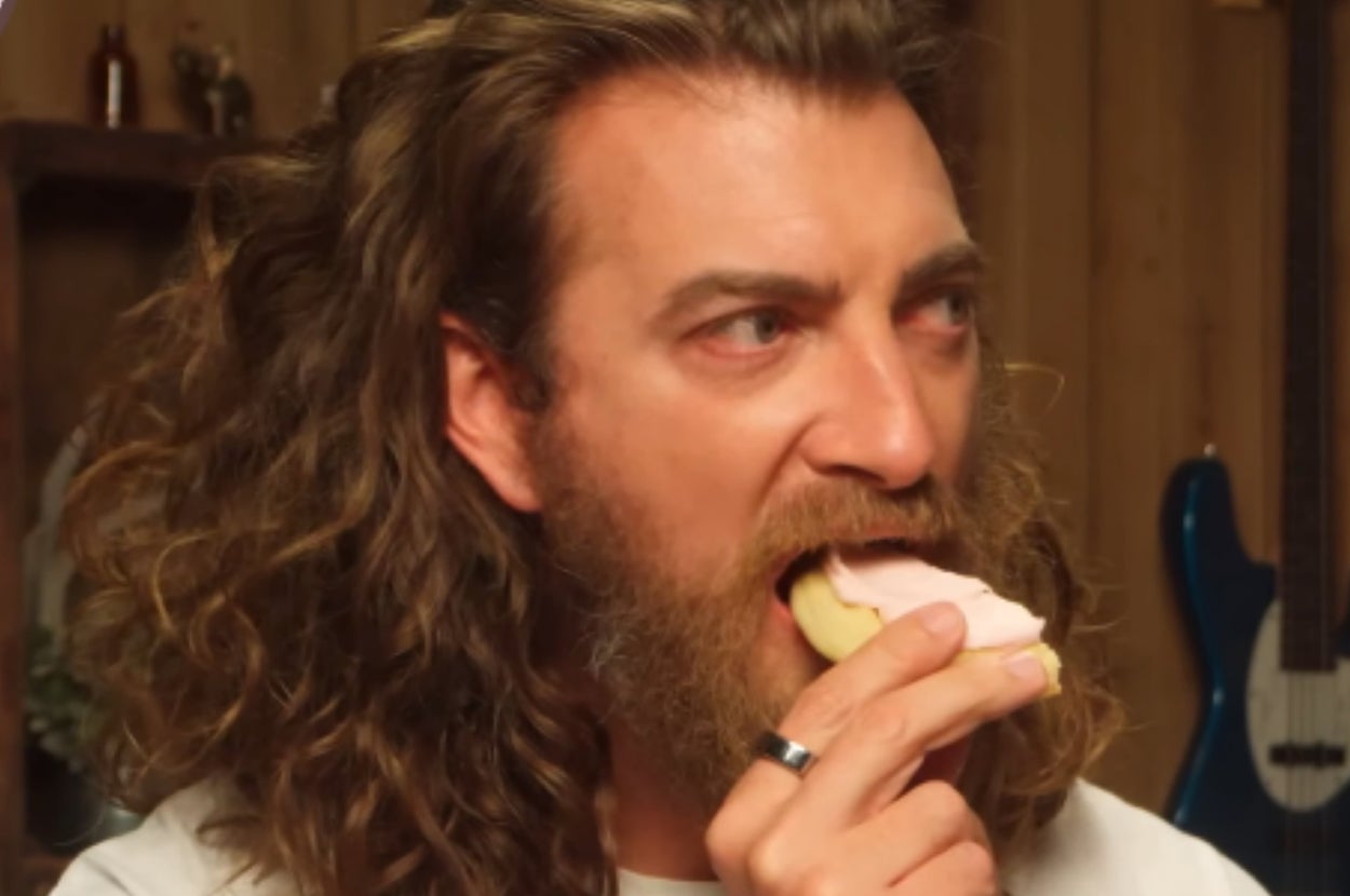 Rhett from Good Mythical Morning eating a Crumbl cookie