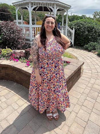 reviewer wearing purple floral dress