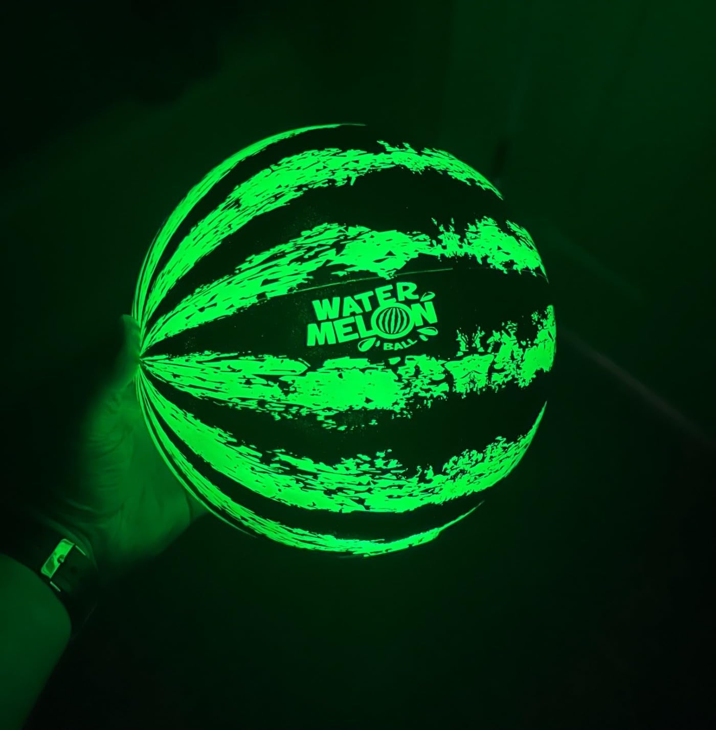 Glowing shot  held successful  1  hand, resembling a watermelon with stripe patterns and 