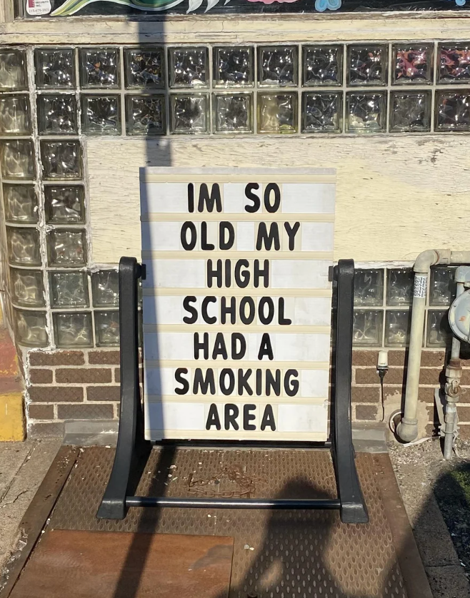 Sign reads: &quot;I&#x27;m so old my high school had a smoking area,&quot; displayed outside a building