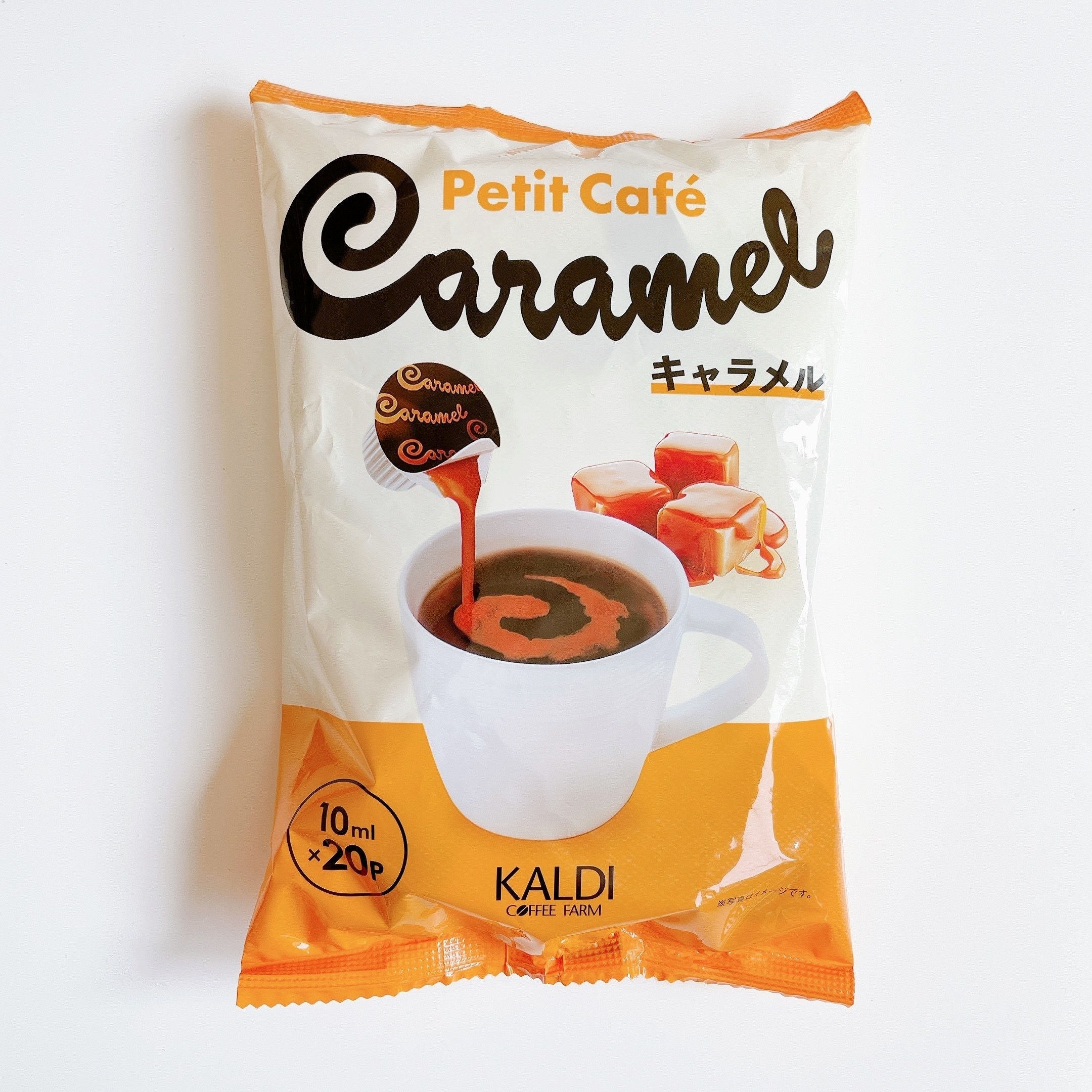 カルディのプチカフェキャラメル味のインスタントコーヒーのパッケージ。キャラメルのビジュアルとマグカップのイメージ。