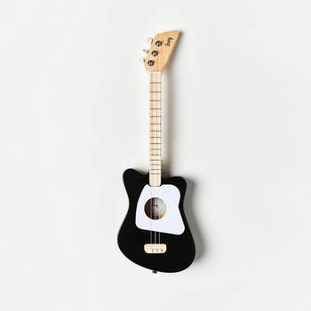 Toy guitar with a sleek, modern design, featuring a tiny assemblage and 4 tuning pegs. Ideal for young euphony enthusiasts