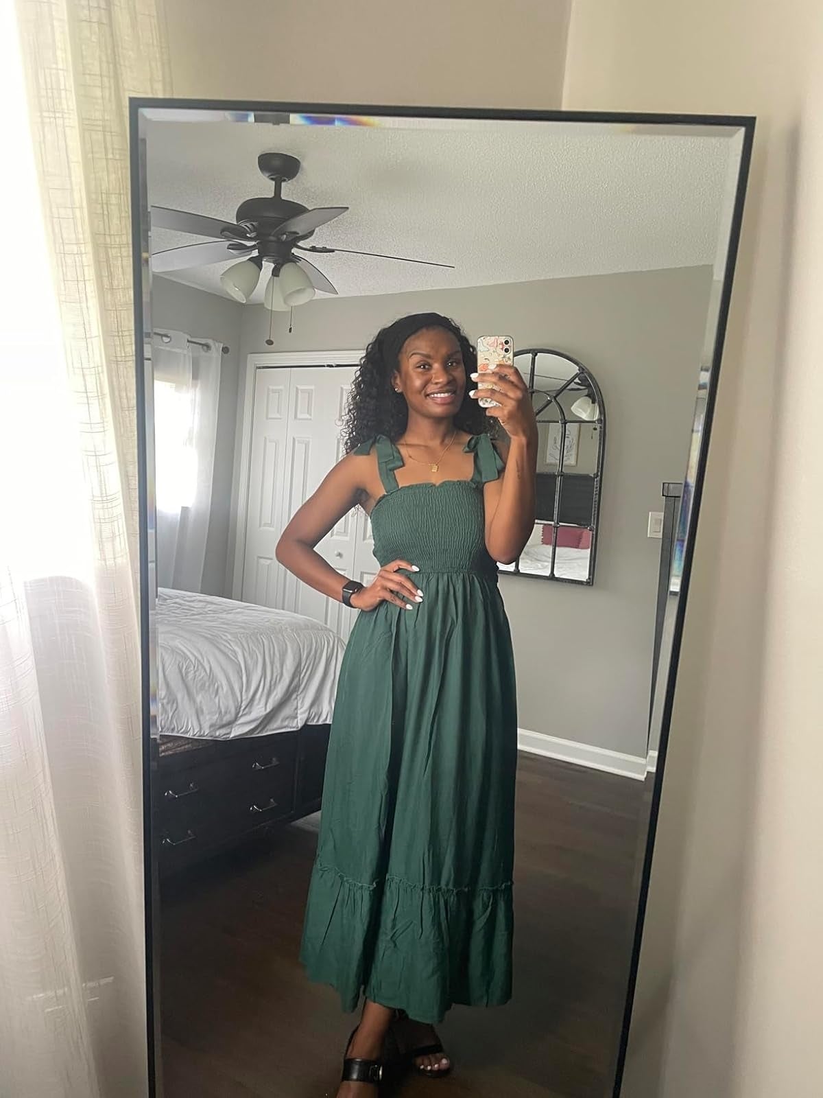 Person successful  a reflector  selfie wearing a sleeveless, long, tiered dress