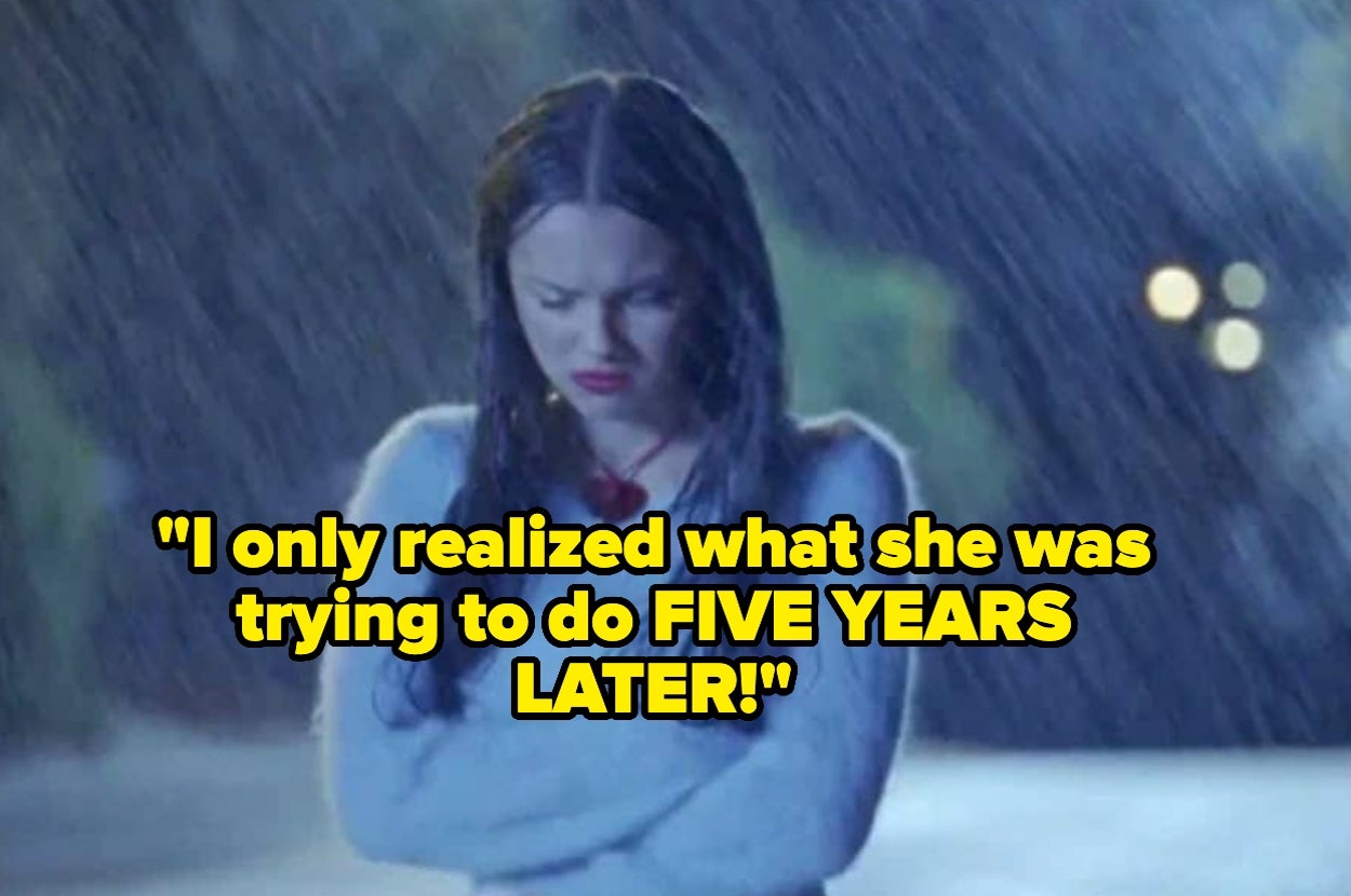 A woman stands alone in the rain, looking down with a serious expression. Text overlay reads: "I only realized what she was trying to do FIVE YEARS LATER!"