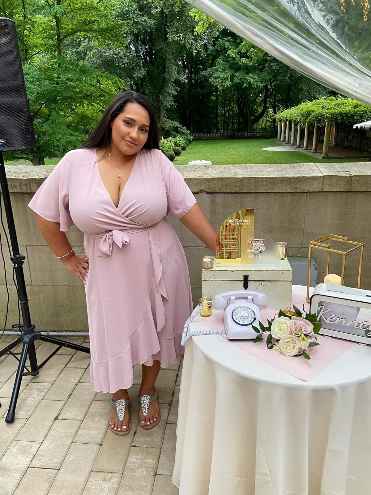 Person successful  a airy  pinkish  wrapper  formal  stands by an elegant array  show  with floral and candle decor