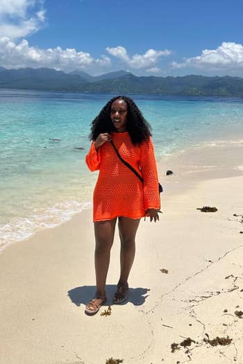 Person connected a sandy formation wearing a crochet cover-up and sandals