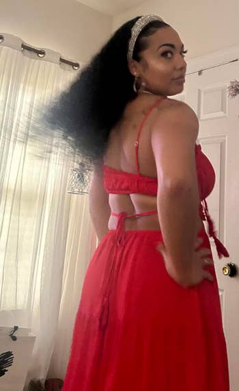 Person successful a flowing formal with a cut-out back, looking implicit their shoulder