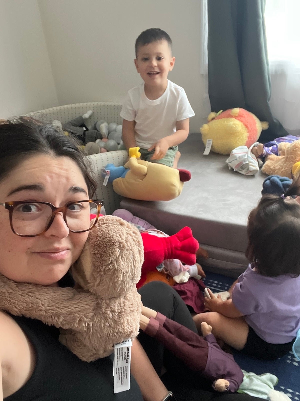 Adults and children successful  a playful country   filled with stuffed animals and toys, creating a airy  and joyful atmosphere