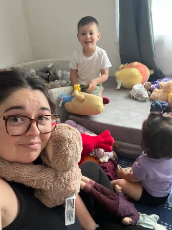 Adults and children successful a playful country filled with stuffed animals and toys, creating a airy and joyful atmosphere