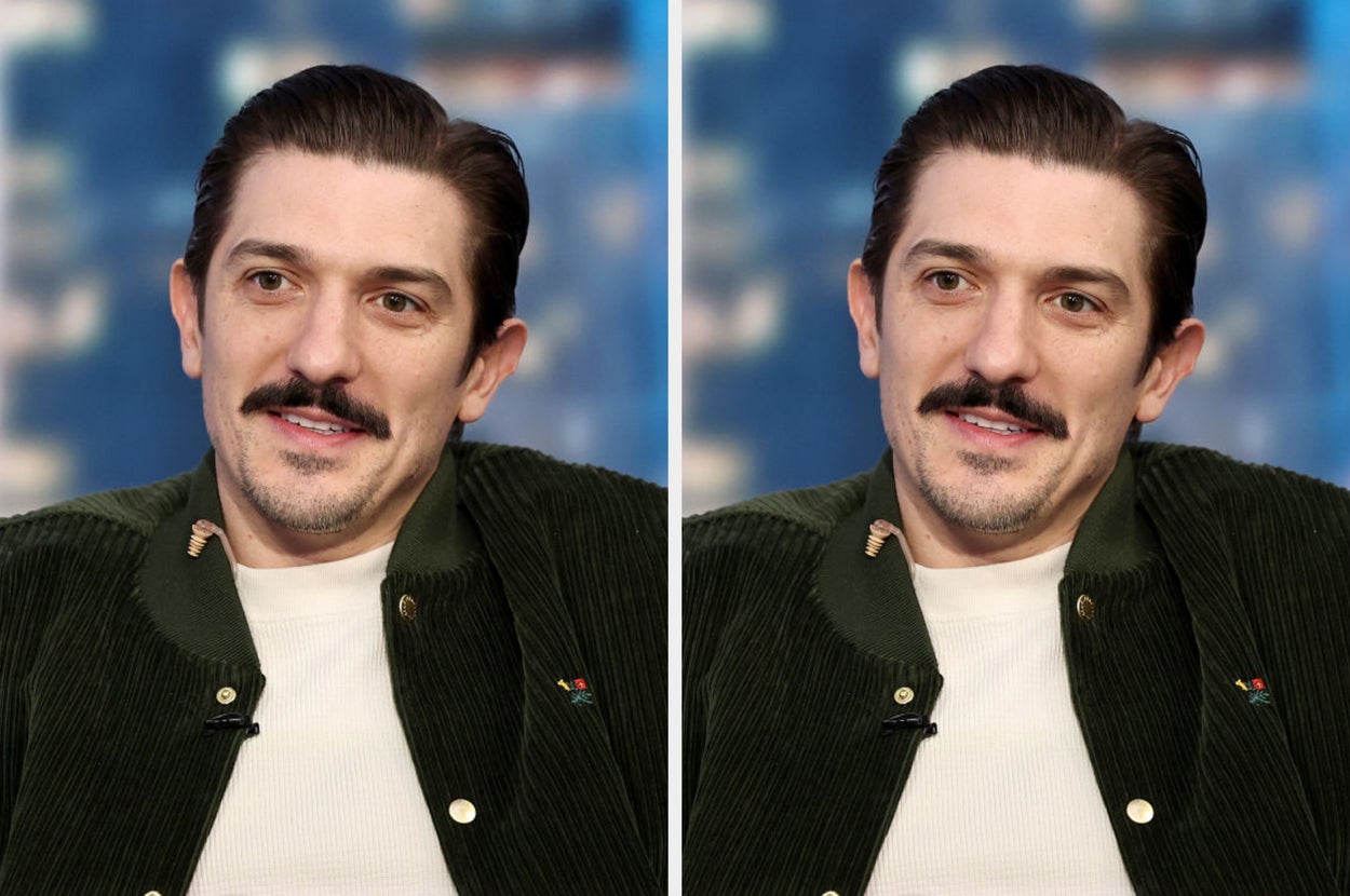 Person with a mustache, wearing a casual green corduroy jacket over a white shirt, is speaking during a TV interview