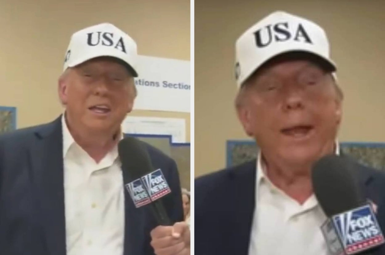 Person wearing a "USA" cap speaks into a microphone labeled with a news logo, appearing to give an interview