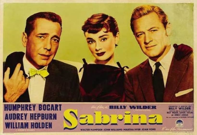 Vintage &quot;Sabrina&quot; movie poster featuring three actors in formal wear, with names Humphrey Bogart, Audrey Hepburn, and William Holden displayed below