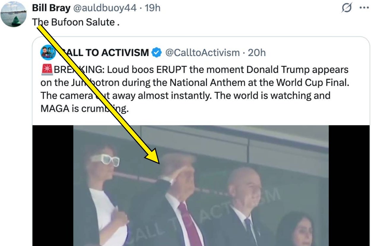 A man and a woman are in a stadium box. The man is saluting. A yellow arrow points to him. Text overlay mentions loud boos during a national anthem