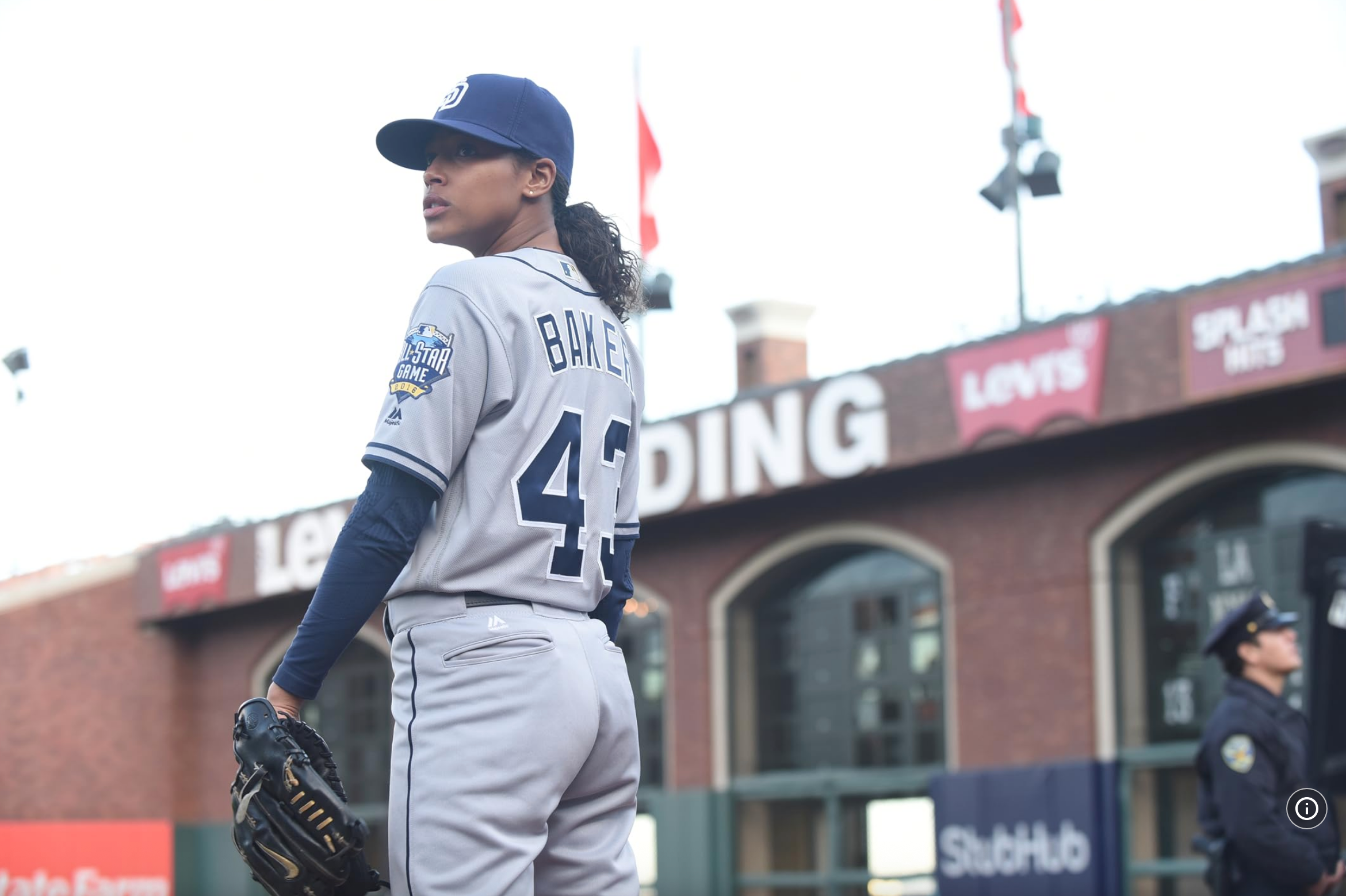 Baseball player wearing a jersey with "Barnes 42" on the back, standing on the field, holding a glove, stadium in the background