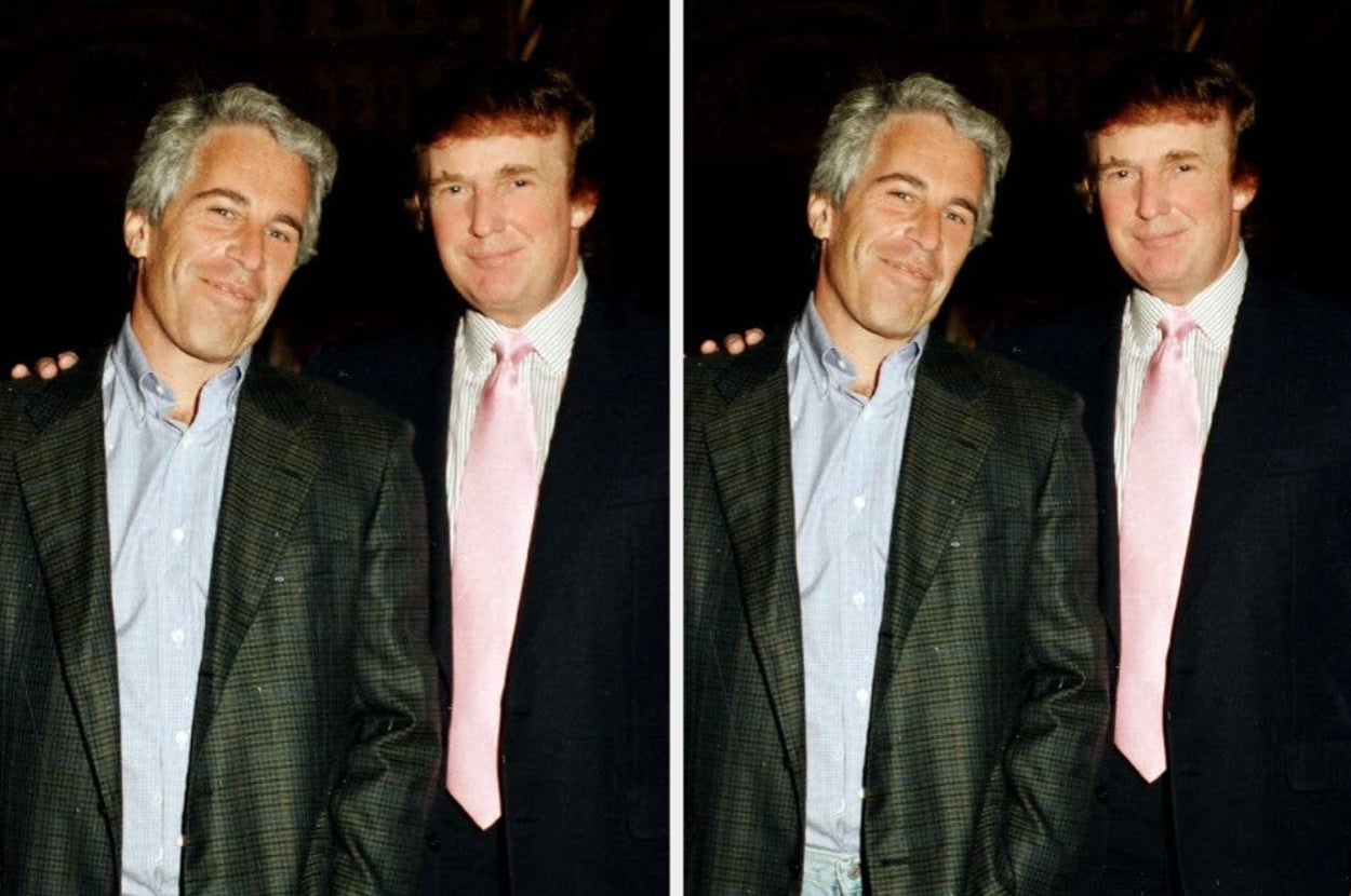 Two men in suits pose together at a formal event, both smiling at the camera