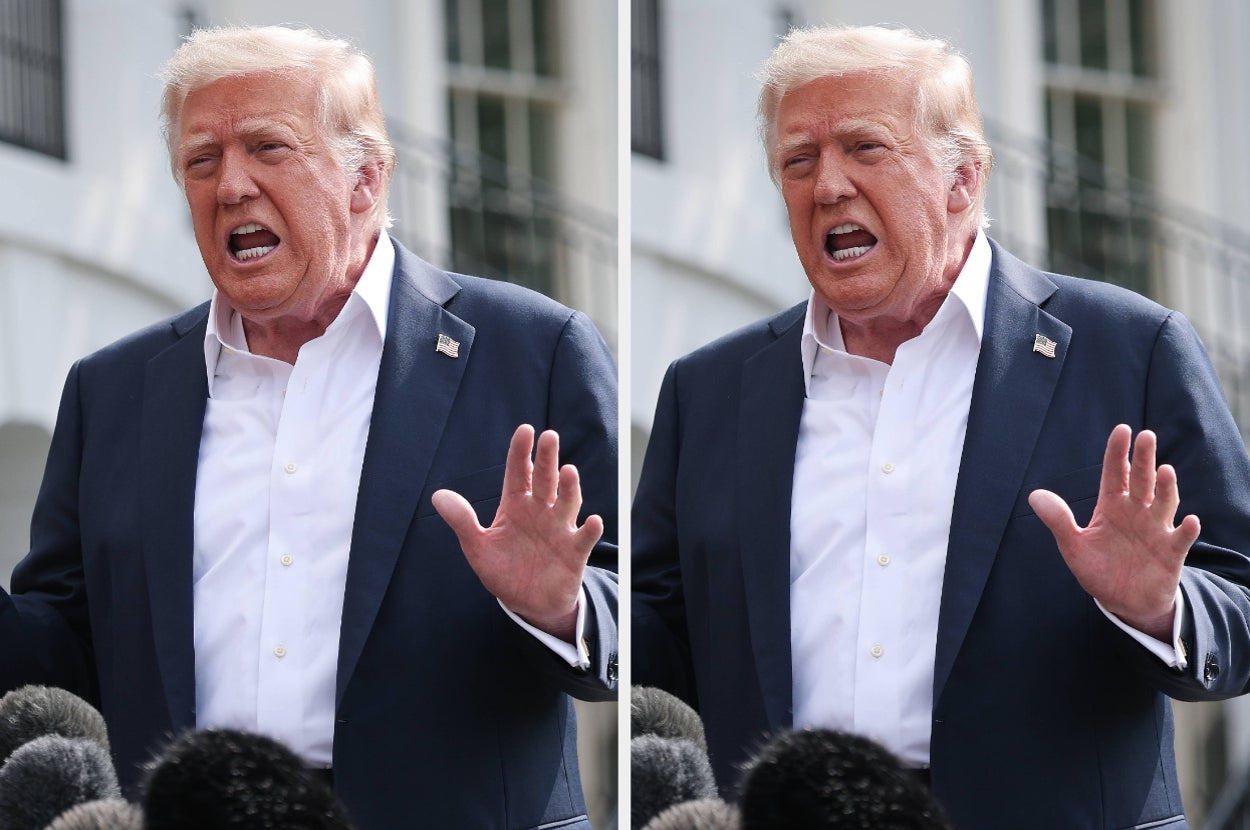 Person giving a speech outdoors, gesturing with hands, surrounded by microphones in a media setting