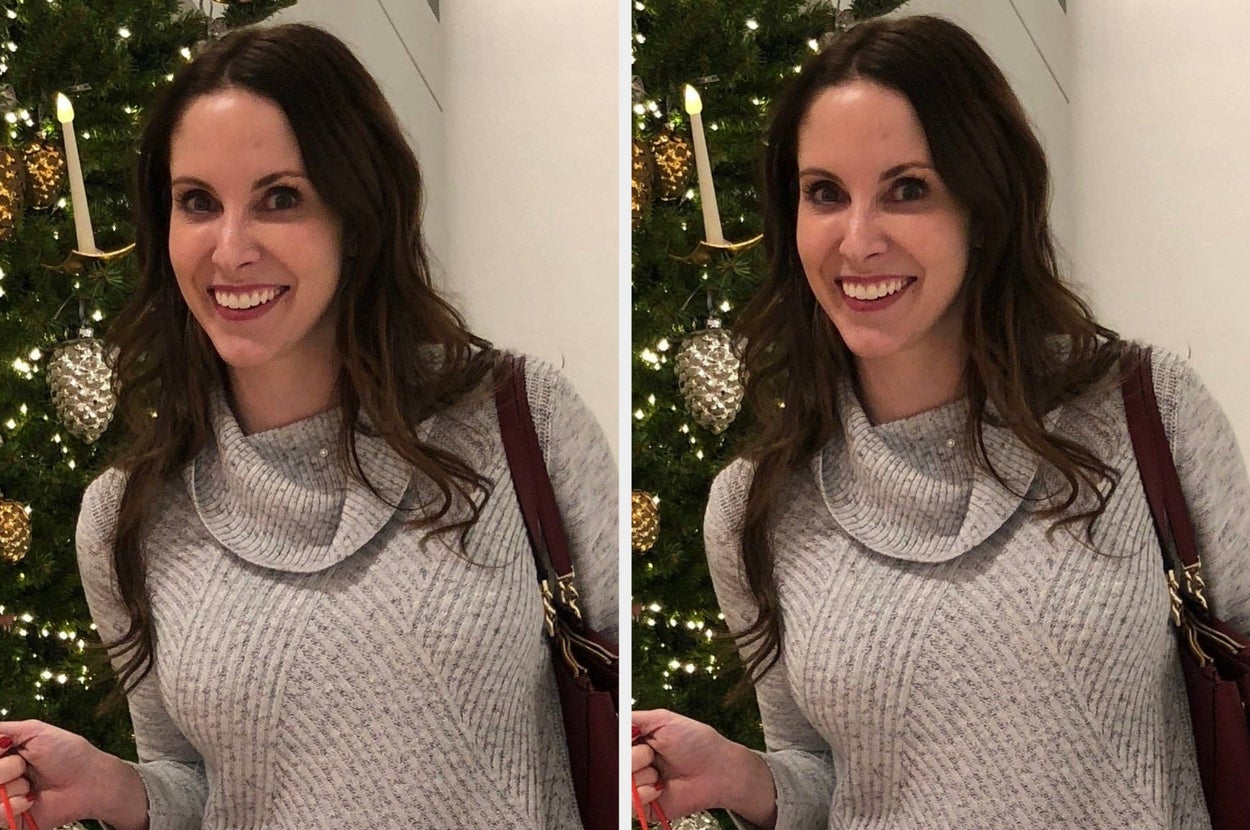 Person smiling in a textured sweater, standing in front of a decorated tree
